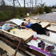 Karlian Mercado, 7, rests on the rubble that remains of her family’s home after it was blown away by Hurricane Maria as it passed through the area, on Sept. 24, 2017, in Hayales de Coamo, Puerto Rico. (Joe Raedle/Getty Images)